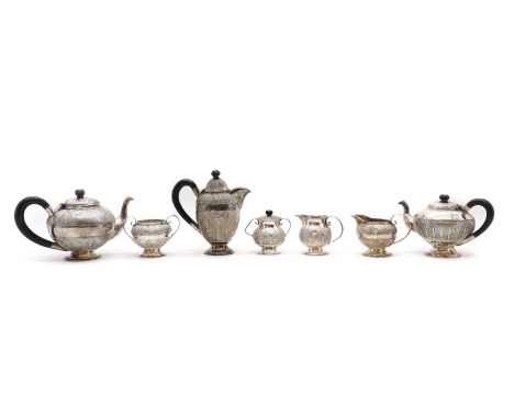 An Iranian silver tea service early to mid 20th century, comprising a hot water pot, 19cm high, teapot, 24cm wide, coffee pot