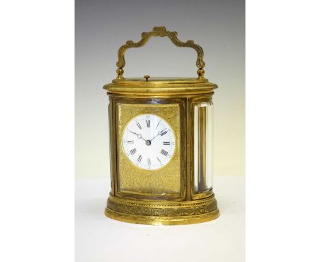 Oval engraved brass-cased repeater carriage clock, anonymous circa 1900, 2.5-inch white circular dial with Roman hours, Arabi
