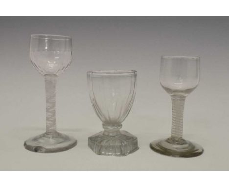 Three drinking glasses, mid-18th Century and later, one with partially moulded rounded bowl, another with ogee bowl both on d