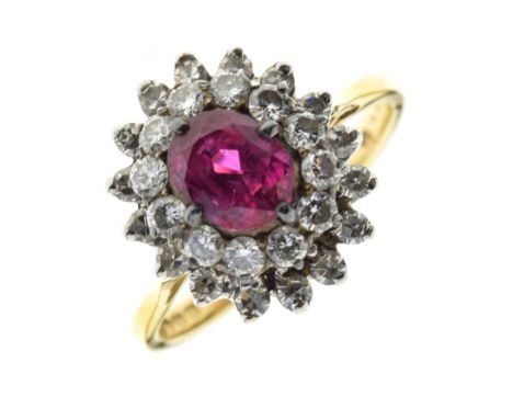 Ruby and diamond 18ct gold cluster ring, the oval cut enclosed by two tiers of brilliant and single cut diamonds, size M, 4.4