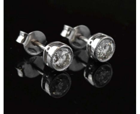 Pair of diamond single stone ear studs, the white mount stamped '750', the millegrain set brilliant cuts of approx 0.35cts ea