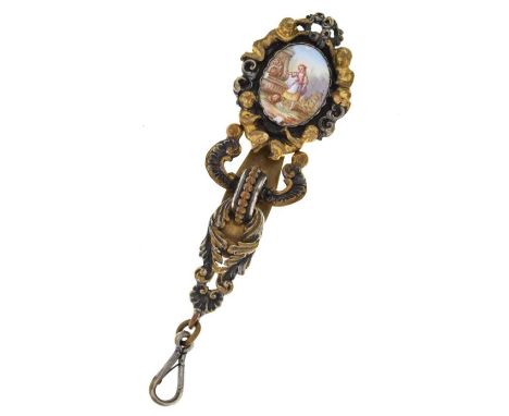 French metal single suspension chatelaine, the oval top panel ceramic set with putti at the corners, with a two-colour rococo