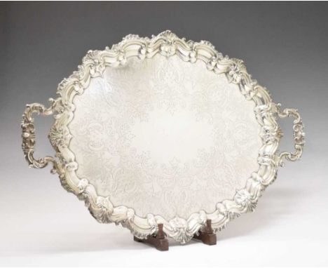 Edward VII silver oval tray with scroll and shell moulded handles and a conforming raised border, having engraved decoration 