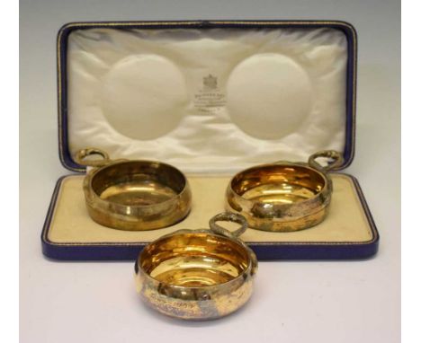 Cased pair of George V silver-gilt tasse de vin cups each with snakehead handles, together with a single example having prese