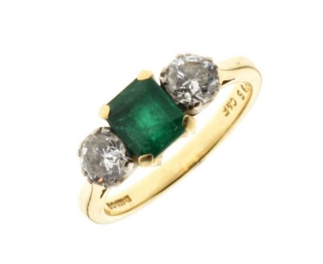 Diamond and emerald three stone 18ct gold ring, the step cut emerald flanked either side by a brilliant cut, the two diamonds