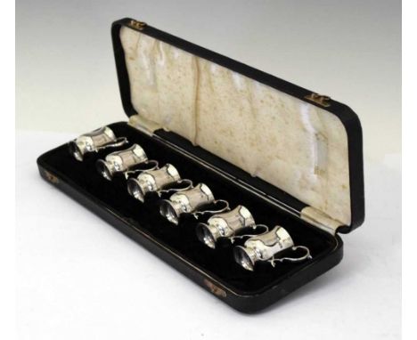 Cased set of six Edward VII silver tot measures in the form of miniature baluster mugs with scroll handles, sponsers mark of 