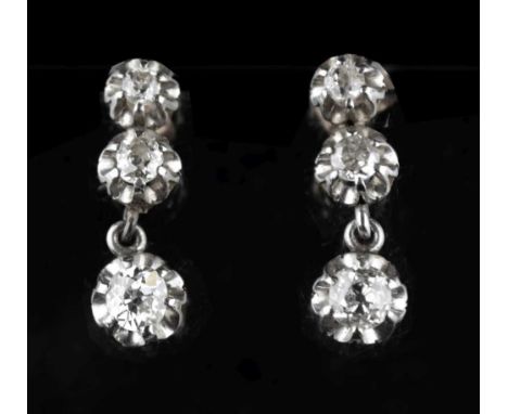 Pair of early 20th Century diamond drop earrings, each with graduated claw set old brilliant cut diamonds, the six stones tot