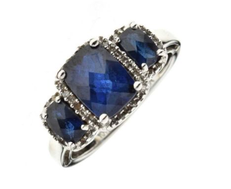 Sapphire and diamond triple cluster ring, the white mount stamped '10K', the three graduated rectangular fancy cut sapphires 