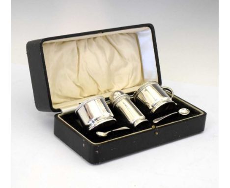 George V silver three piece condiment set, the salt and mustard having blue glass liners, sponsors mark of William Davenport 