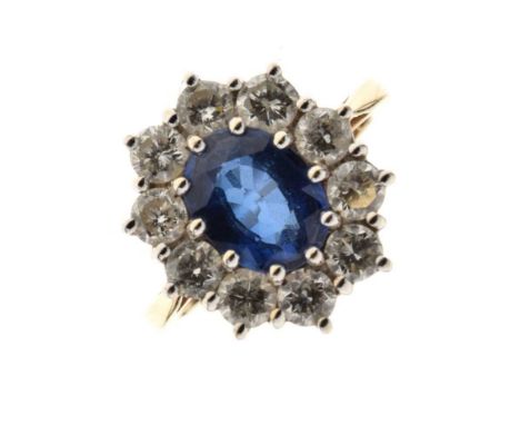 Sapphire and diamond cluster ring, in 18ct gold, the oval cut sapphire stated as weighing 2 carats, enclosed by ten brilliant