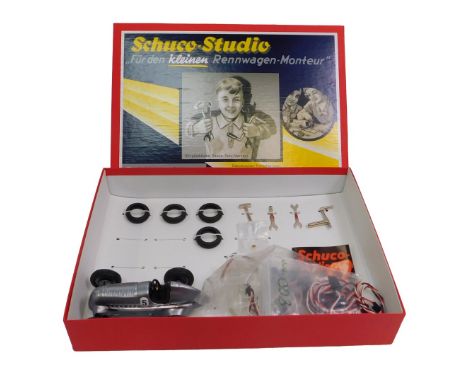 A Schuco Studio 1936 Mercedes Benz race car, in silver, together with accessories, boxed. 