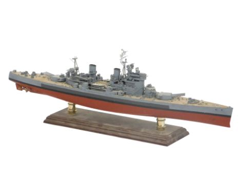 A wooden and plastic scale model of a World War II battleship, on a cradle stand, 65cm wide. 