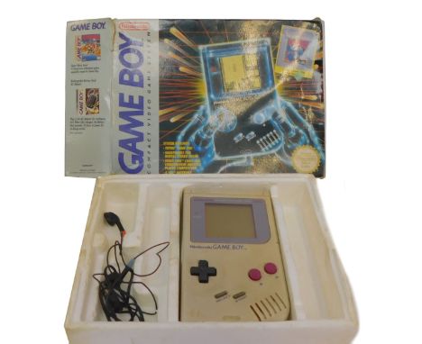 A Nintendo Game Boy compact game system, boxed, including Tetris game pack and headphones.
