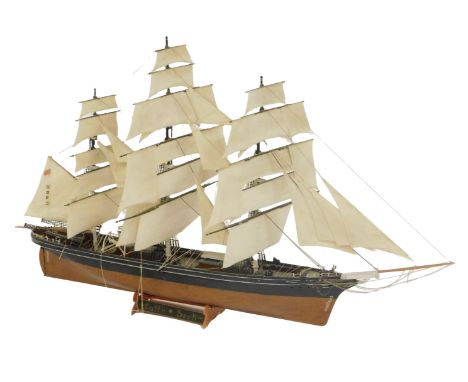 A scale model of the Cutty Sark, fully rigged under sail.