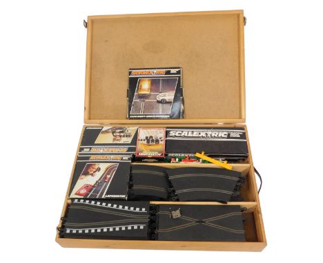 A group of Scalextric, including a hump bridge, auto start, lap counter, tracks, and railing, some boxed, with outer casing.