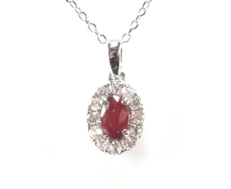 A hallmarked 18ct gold ruby and diamond pendant necklace. The necklace strung with a ruby and diamond pendant. Hallmarked She