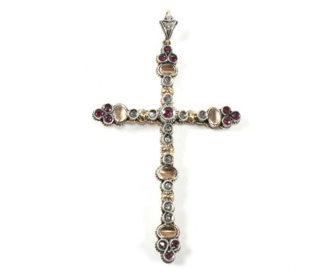 French ruby and diamond cross pendant. The pendant set with rubies and diamonds with bale to top. Unmarked tests indicate gol