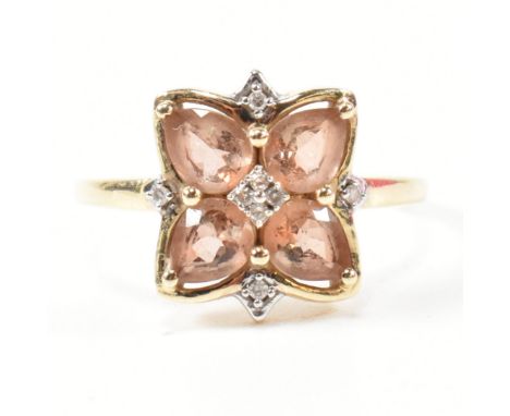 A hallmarked 9ct gold pink stone and diamond cluster ring. The ring having a clover shaped mount set with four button prong s