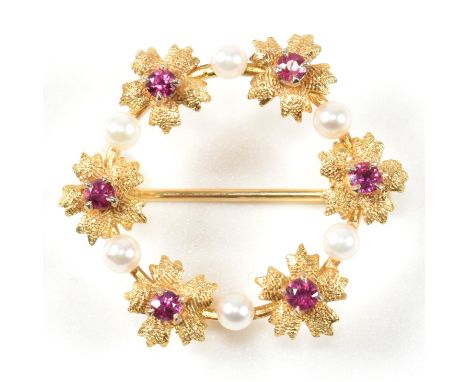 Early 20th century  ruby and pearl garland brooch pin. The brooch formed with a garland of ruby set flowers with pearl accent