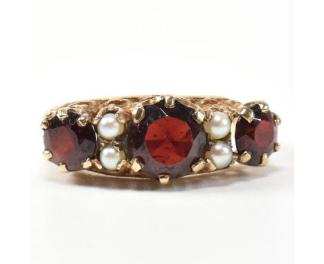 A 1960s hallmarked 9ct gold, garnet and pearl half hoop ring. The ring having three graduating round cut garnets interspaced 