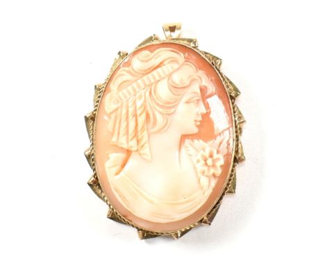 A hallmarked 9ct gold shell cameo brooch pin. The oval shell cameo being carved with the profile of a lady set in a gold fram