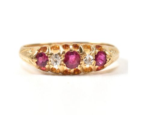 An early 20th century hallmarked 18ct gold, ruby and diamond gypsy ring. The ring having a central oval cut ruby flanked by t