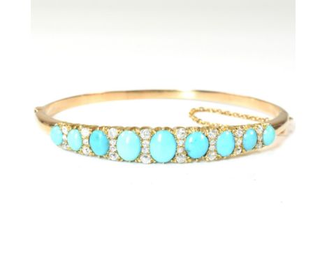 A late Victorian gold, turquoise and diamond hinged bangle. The gold hinged bangle set with nine graduating oval cut turquois