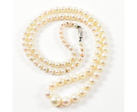 A 9ct white gold and cultured pearl necklace. The single strand necklace strung with ninety five graduating cultured pearls t