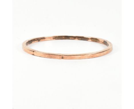 A hallmarked 9ct rose gold bangle bracelet. The flat 9ct rose gold bangle, hallmarked for Birmingham, 1925. Maker's mark JS f