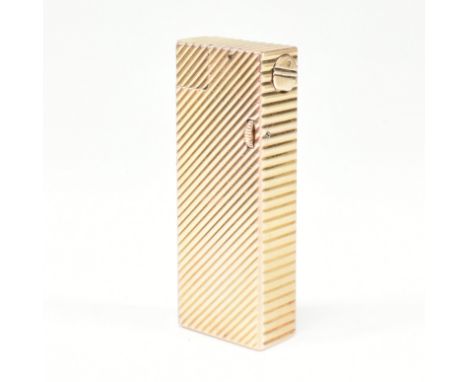 A vintage Dunhill Paris gold plated lighter. The lighter having chevron decoration with roller action. Signed Dunhill Paris t