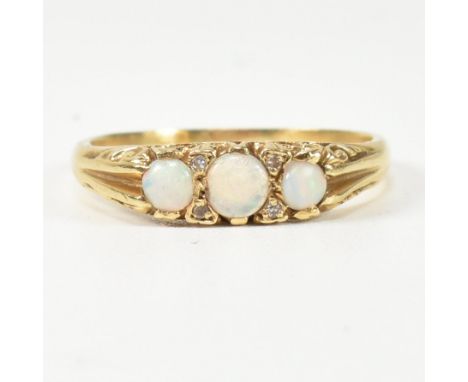 A hallmarked 18ct gold, opal and diamond half hoop ring. The ring having three round opal cabochons punctuated by four round 