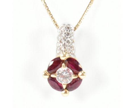 An Italian 18ct gold, ruby and diamond target pendant necklace. The 18ct yellow gold box chain necklace strung with a target 