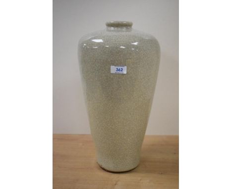 A large 20th century colossal style ceramic vase, decorated in crackle glaze on a cream ground, h40cm.