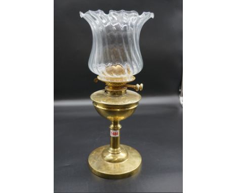 An antique brass oil lamp, height including shade 47cm.&nbsp; 