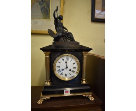 A slate and brass mantle clock,&nbsp;with spelter figural surmount, 47.5cm high, with pendulum.&nbsp; 