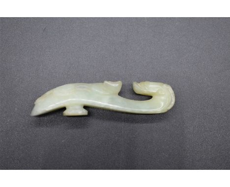 A Chinese carved celadon jade buckle,&nbsp;9cm long.&nbsp; 