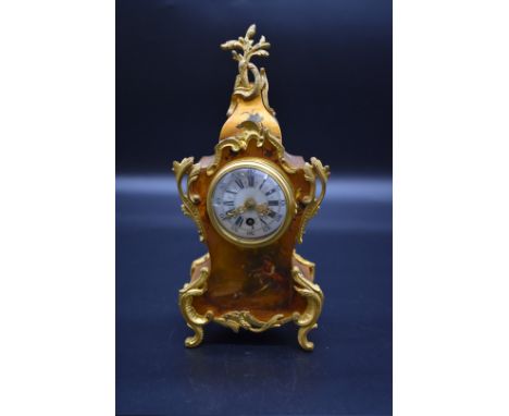 A Louis XV style brass and gilt mantel timepiece,&nbsp;with enamel dial and painted decoration, 25cm high. 