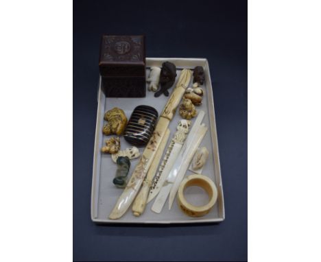 A collection of Japanese and other Eastern carved bone and ivory;&nbsp;together with a small tortoiseshell purse, and an Edwa