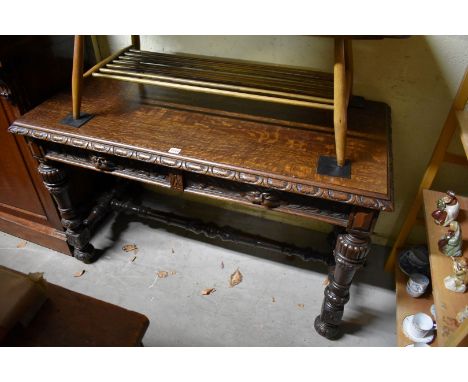 A Victorian carved oak two drawer side table,&nbsp;stamped 'Edwards &amp; Roberts', 121cm wide.&nbsp; 