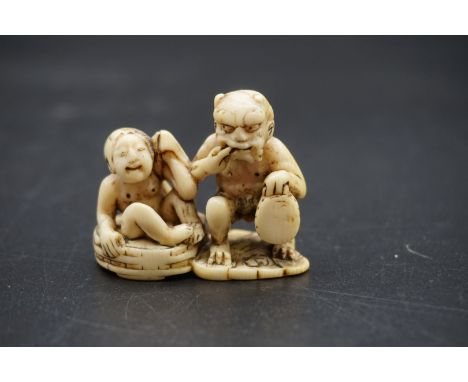 A good Japanese carved ivory netsuke, Edo, depicting Raijin and Okame in a bathtub, 4.5cm wide. 