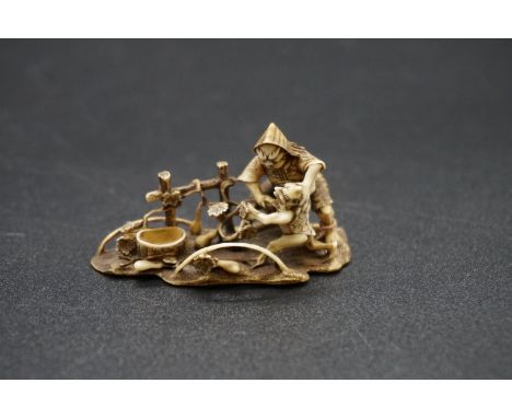 A fine and intricate Japanese carved ivory netsuke, by Gyokuzan, Edo, depicting a demon and tortoise in a garden, signed on i