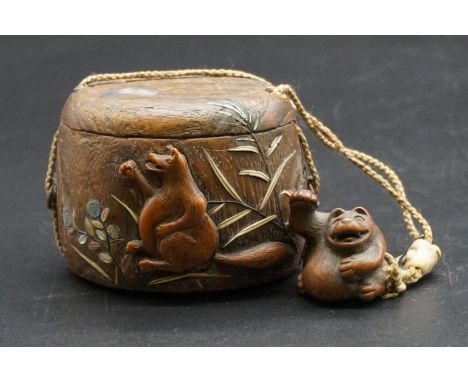 A good Japanese wood and inlaid tonkotsu, Edo, signed, 9cm wide; with attached monkey netsuke, signed; and bone ojime.&nbsp;&