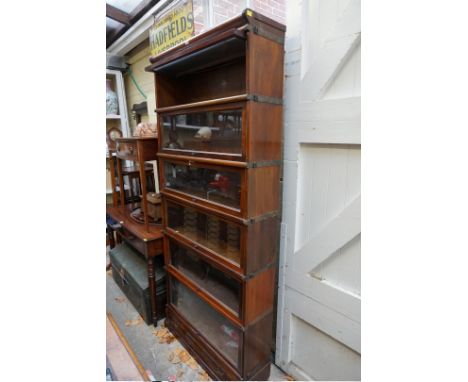 An early 20th century Globe Wernicke mahogany six tier sectional bookcase, with apron drawer, 86.5cm wide. 