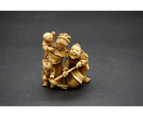 A good and large Japanese carved ivory netsuke figure group, 19th century, depicting a man, woman and two children, signed on