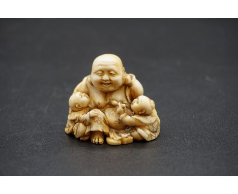 A good Japanese carved ivory netsuke, Edo, depicting Hotei and two Karako, signed, 4cm high. 