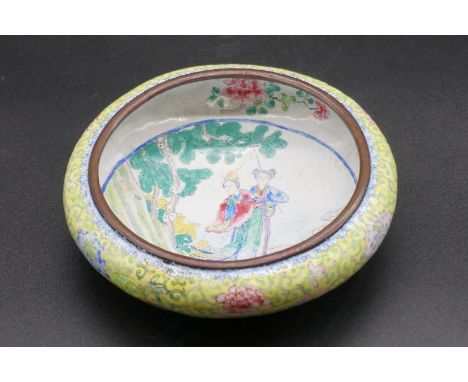 A Chinese canton enamel bowl, Qianlong four character mark and probably of the period, painted to the centre two ladies in a 