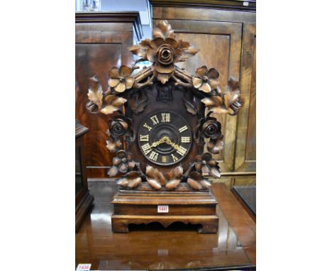 A large 19th century Black Forest carved walnut cuckoo clock,&nbsp;striking on a gong, 59cm high, with associated mahogany br