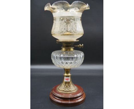 An antique brass oil lamp,&nbsp;with amber stained shade, eight including shade 47.5cm.&nbsp; 