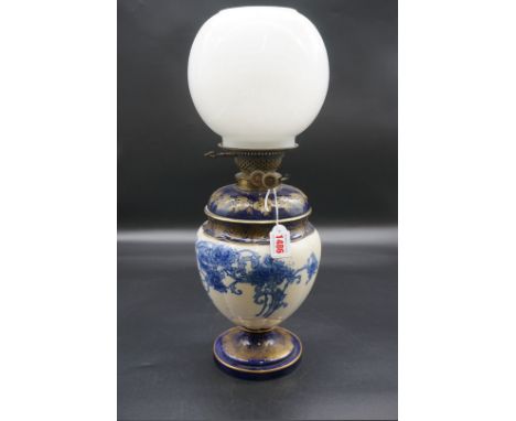 An antique blue and white pottery oil lamp, height including opaque white glass shade 51cm.&nbsp; 