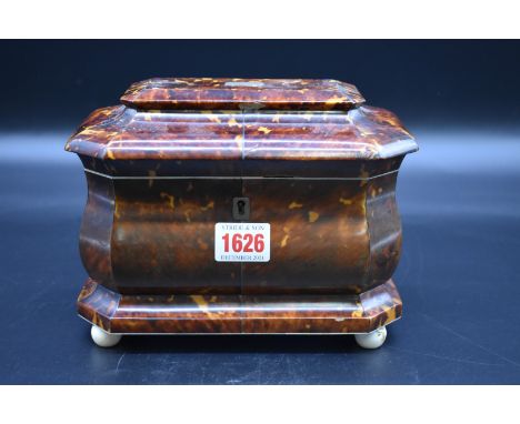 A 19th century tortoiseshell tea caddy,&nbsp;on ivory feet, 20.5cm wide.&nbsp; 